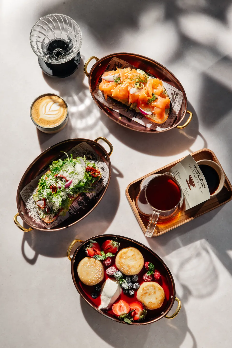 A sunlit Monoblend table filled with brunch, coffee, and tea